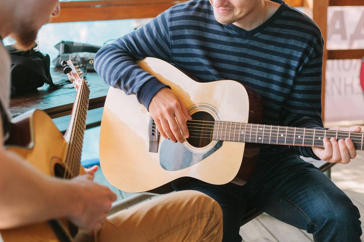 Man Holding The Guitar